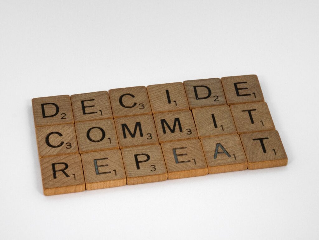 Decide Commit Repeat - wooden letters